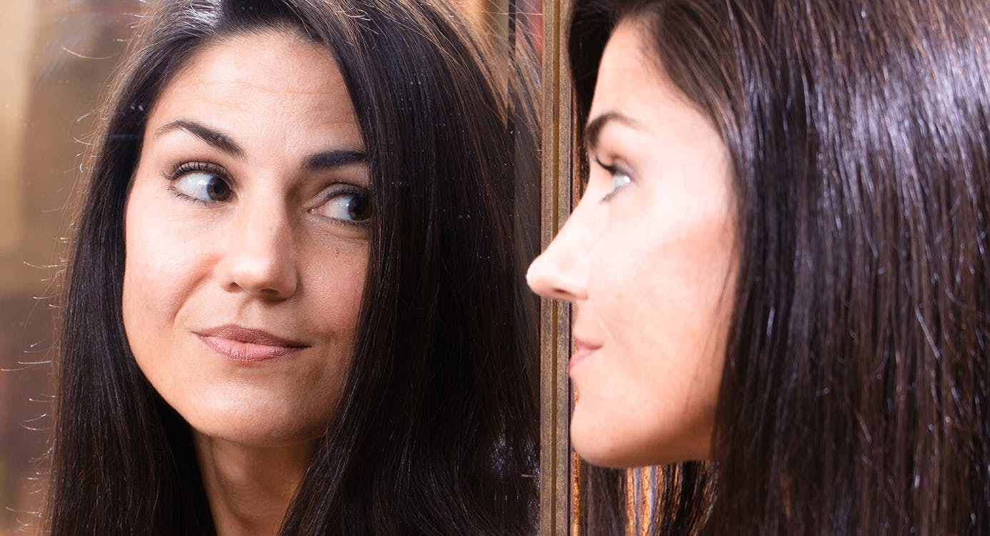 Woman Looking at Her Reflection