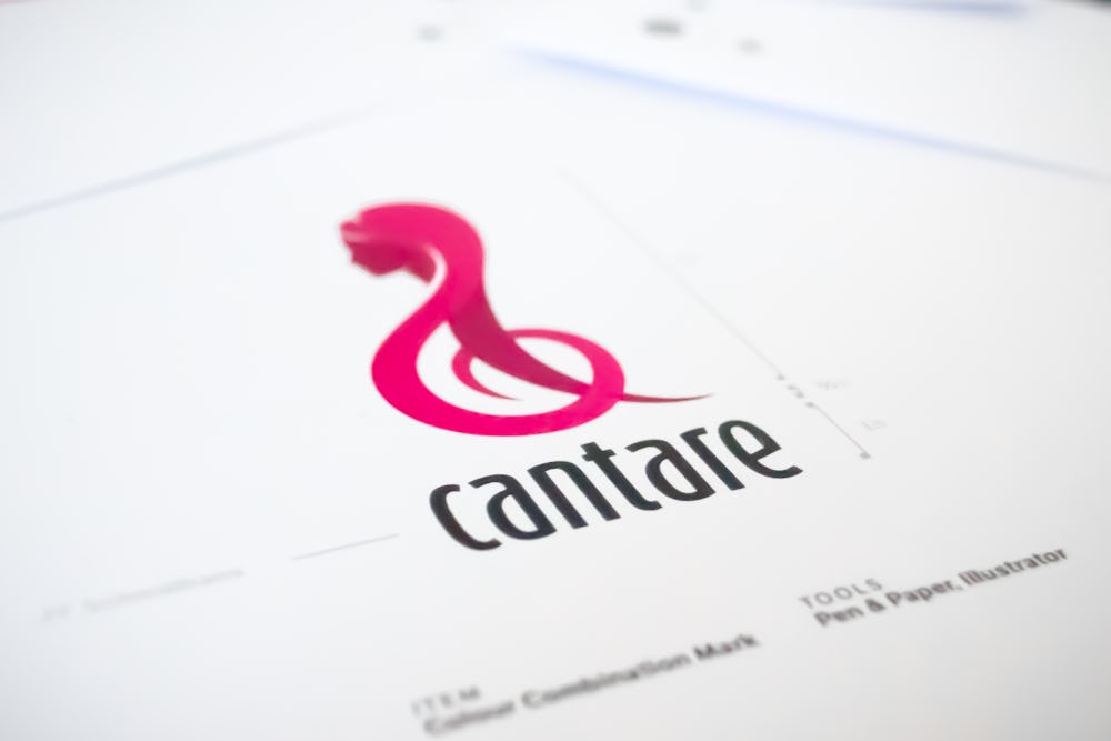 Bright pink treble clef shaped logo