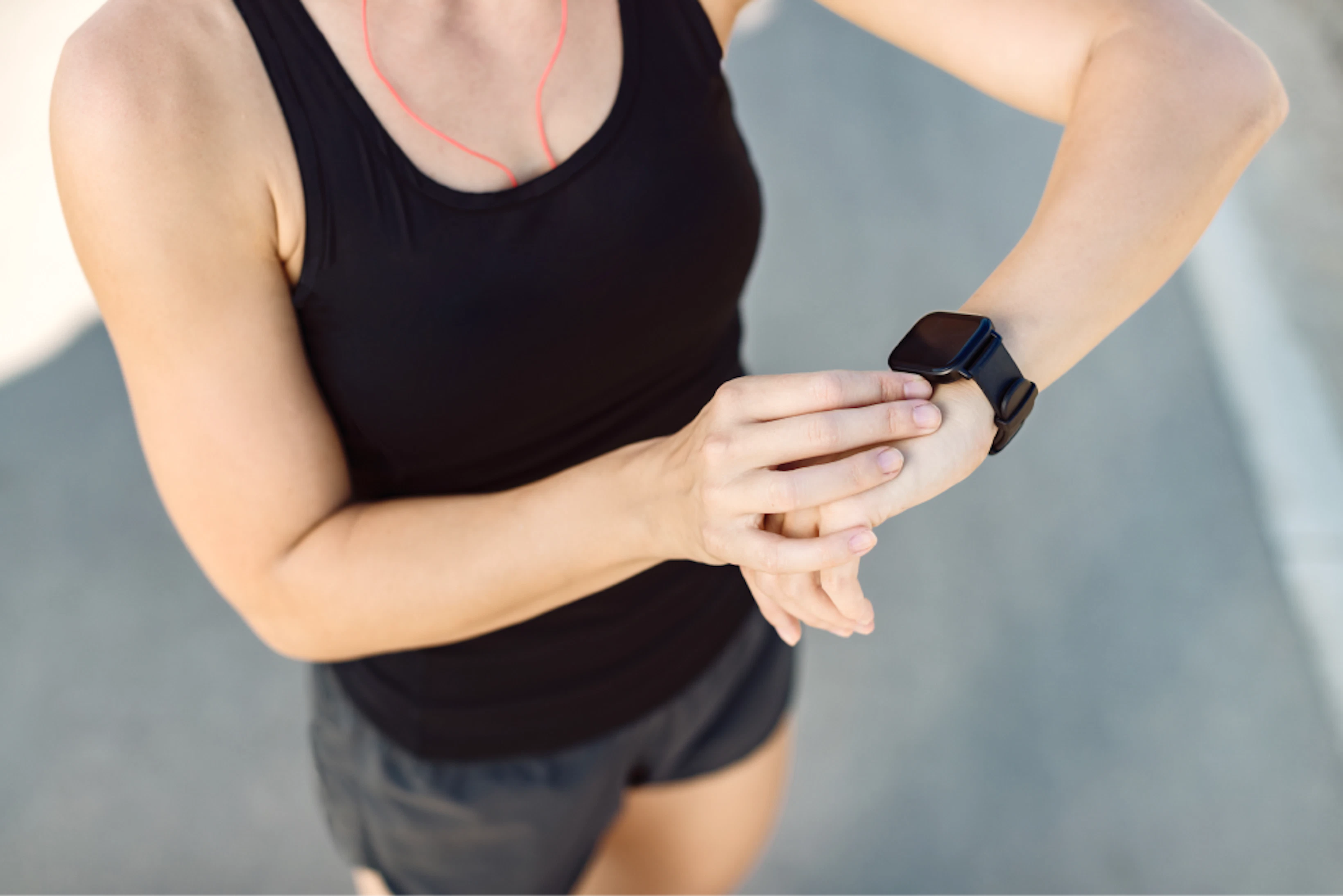 closeup athletic woman using fitness tracker outdoors 1