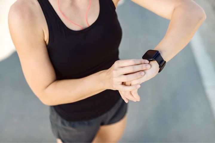 closeup athletic woman using fitness tracker outdoors 1