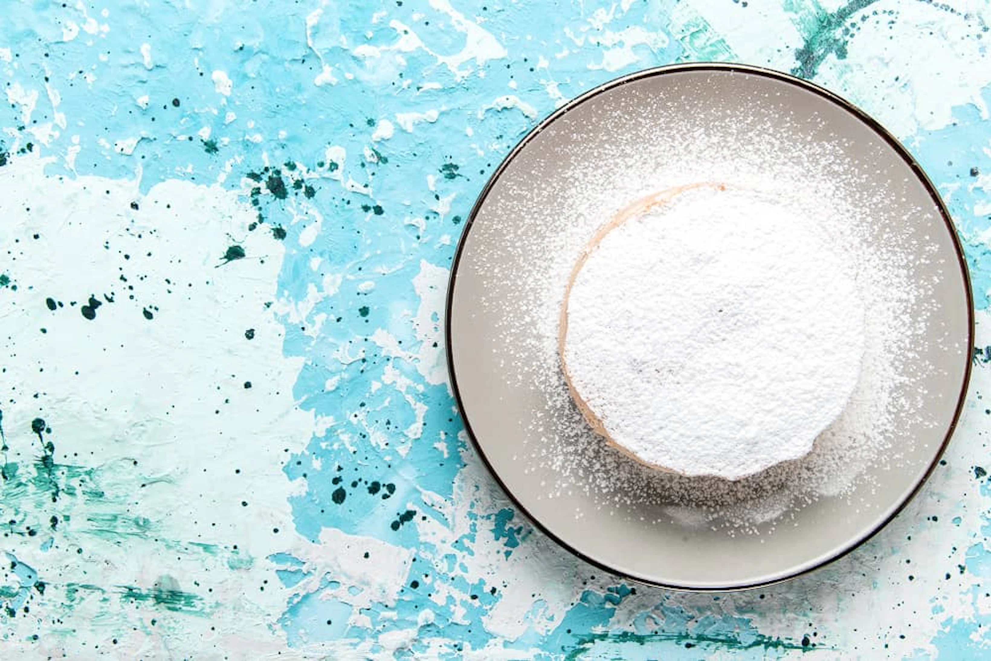 top close view round cake with sugar powder inside plate light blue surface cake bake biscuit sugar sweet tea color 1