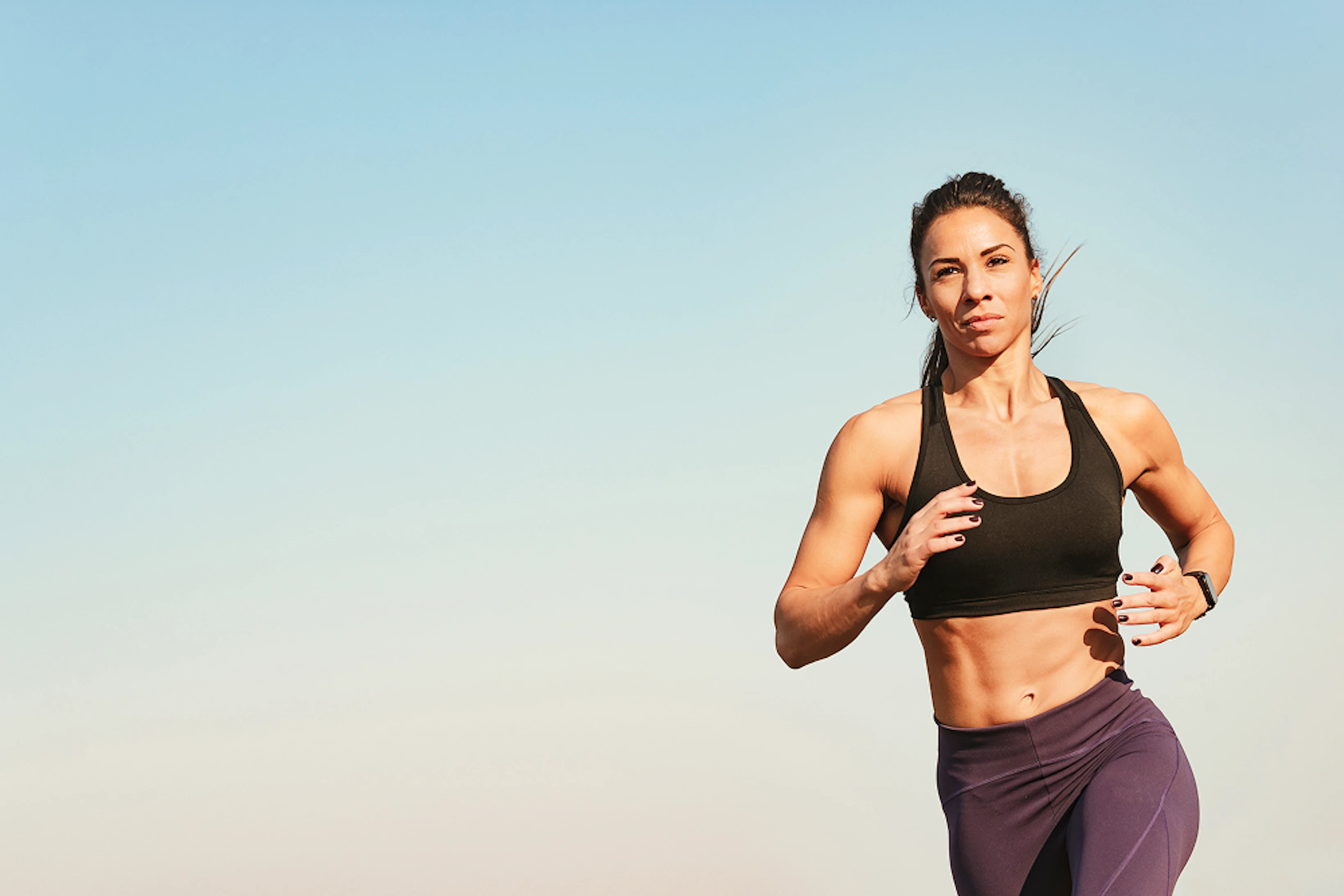 young fitness instructor feeling motivated while running against sky copy space 1