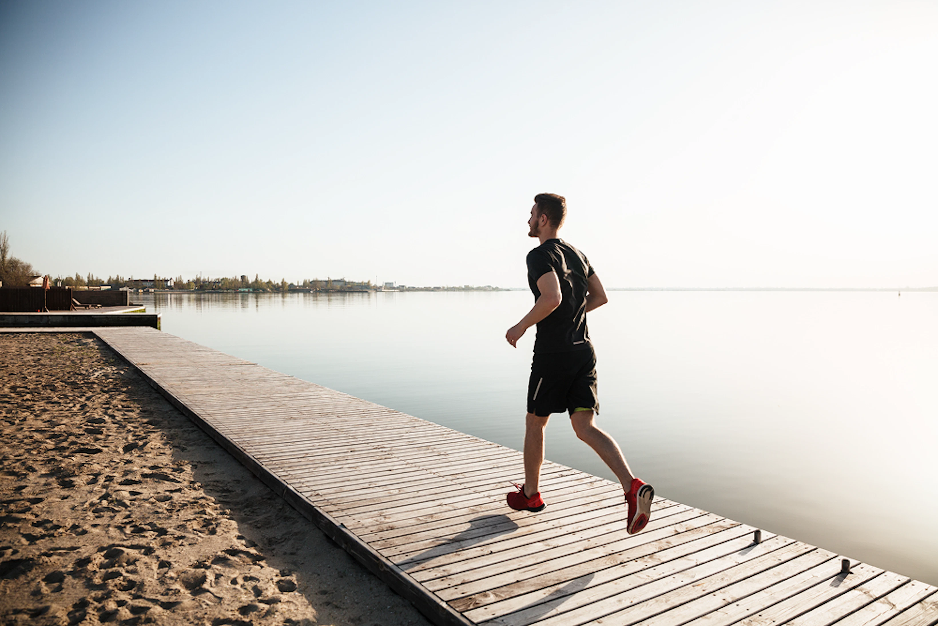 back view full length portrait young sportsman running 1