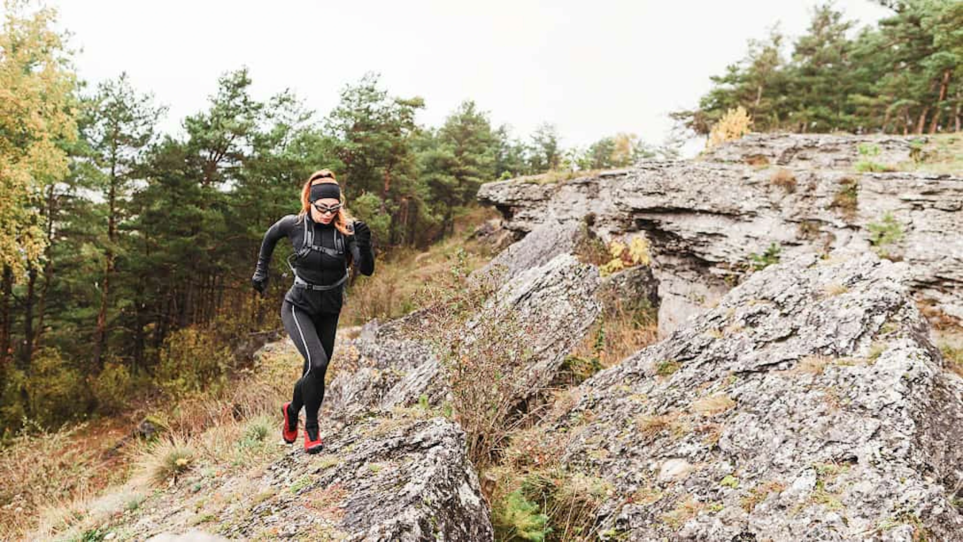 female sporty jogger running stones long shot 1