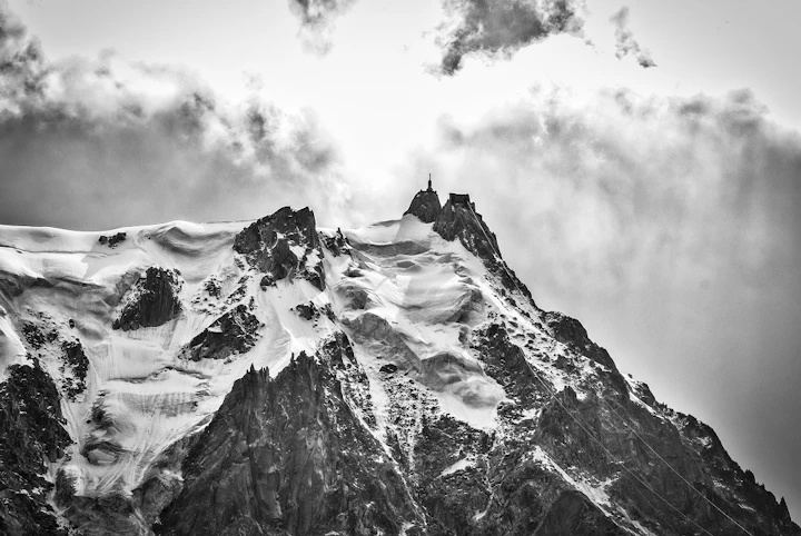 grayscale shot famous aiguille du midi mountain covered with snow france 1