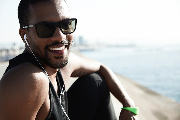 young fit man beach wearing sunglasses 1