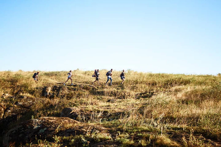 young beautiful friends travelers with backpacks walking canyon 1