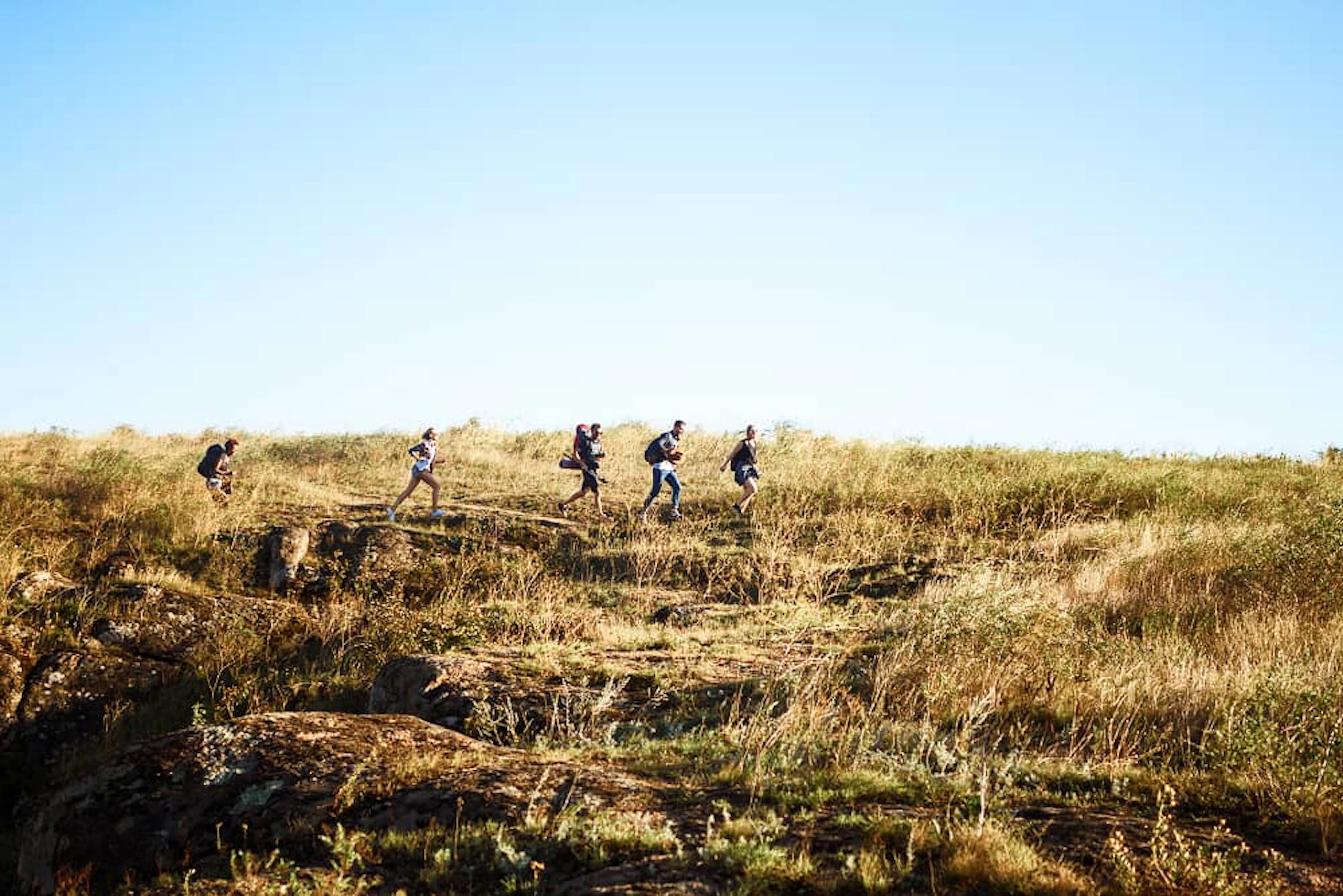 young beautiful friends travelers with backpacks walking canyon 1