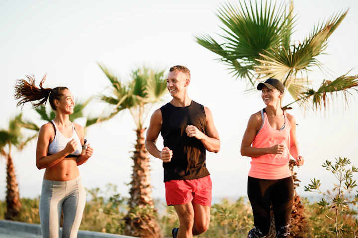 group smiling athletic people running together outdoors 1