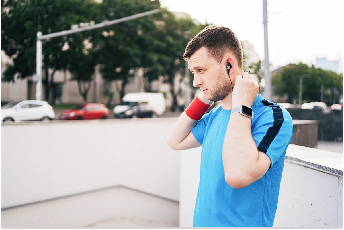 man getting ready city workout arranging earphones 1