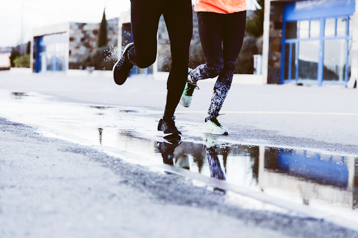 low section two athletes running street 1