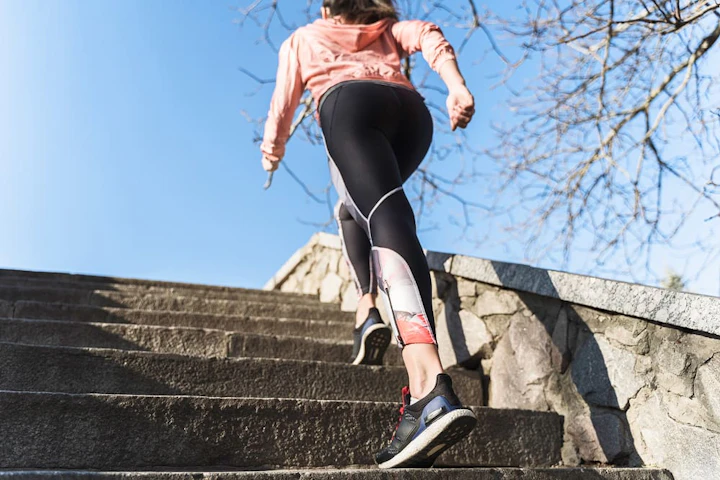 fit young woman climbing stairs outdoor 1