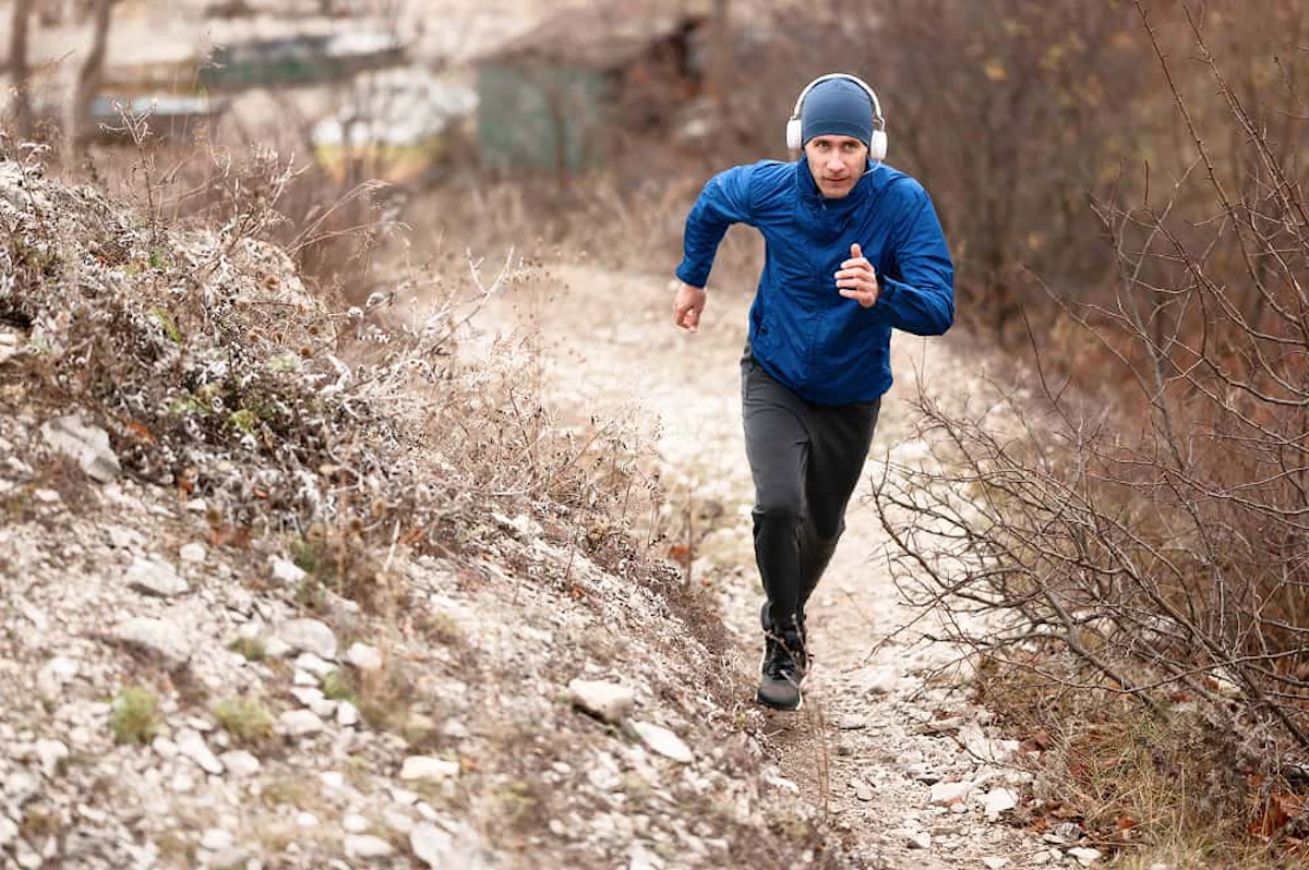 full shot man running trail nature 1