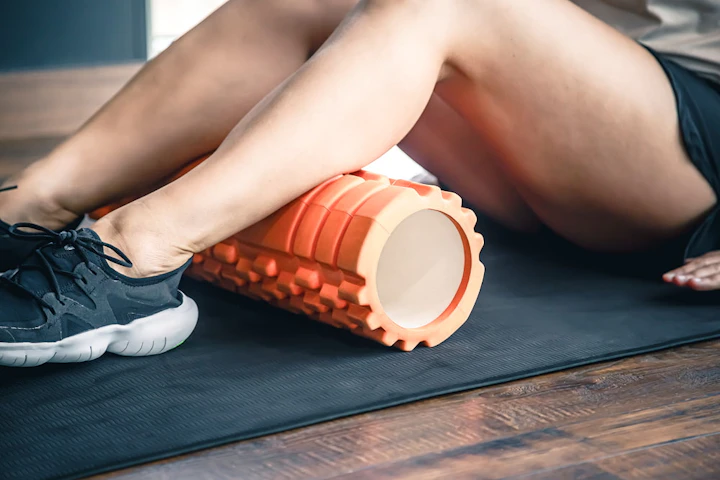 sport woman using foam roller muscle fascia stretching foot 1