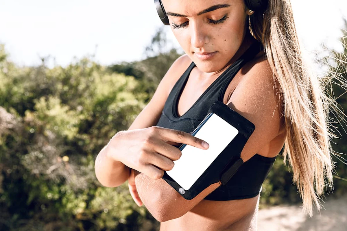 woman using her phone armband mock up 1
