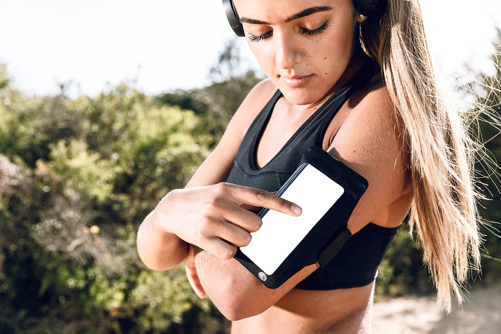woman using her phone armband mock up 1