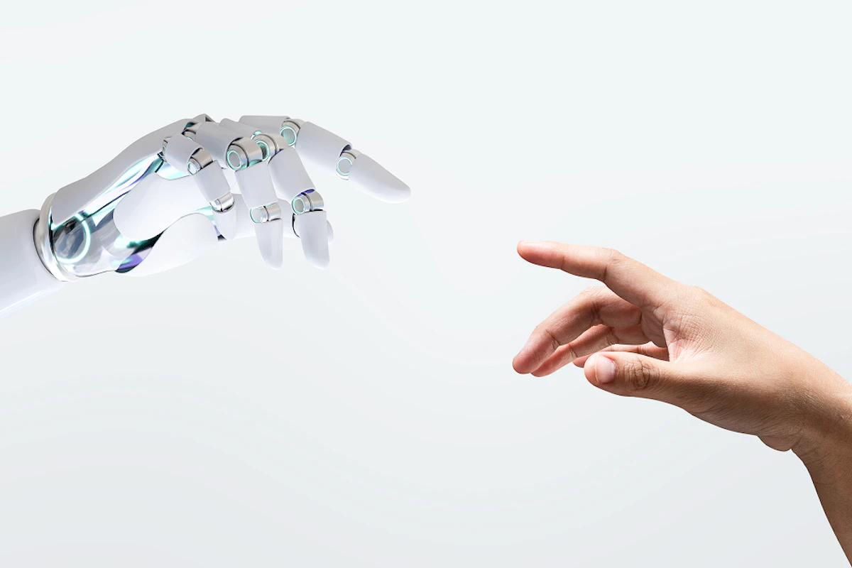 Main d'un robot et main d'un humain prêtes à se toucher de l'index