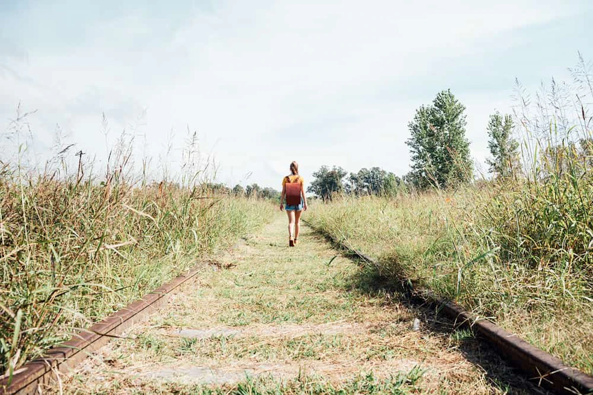 femme marche sur une longue voie ferrée