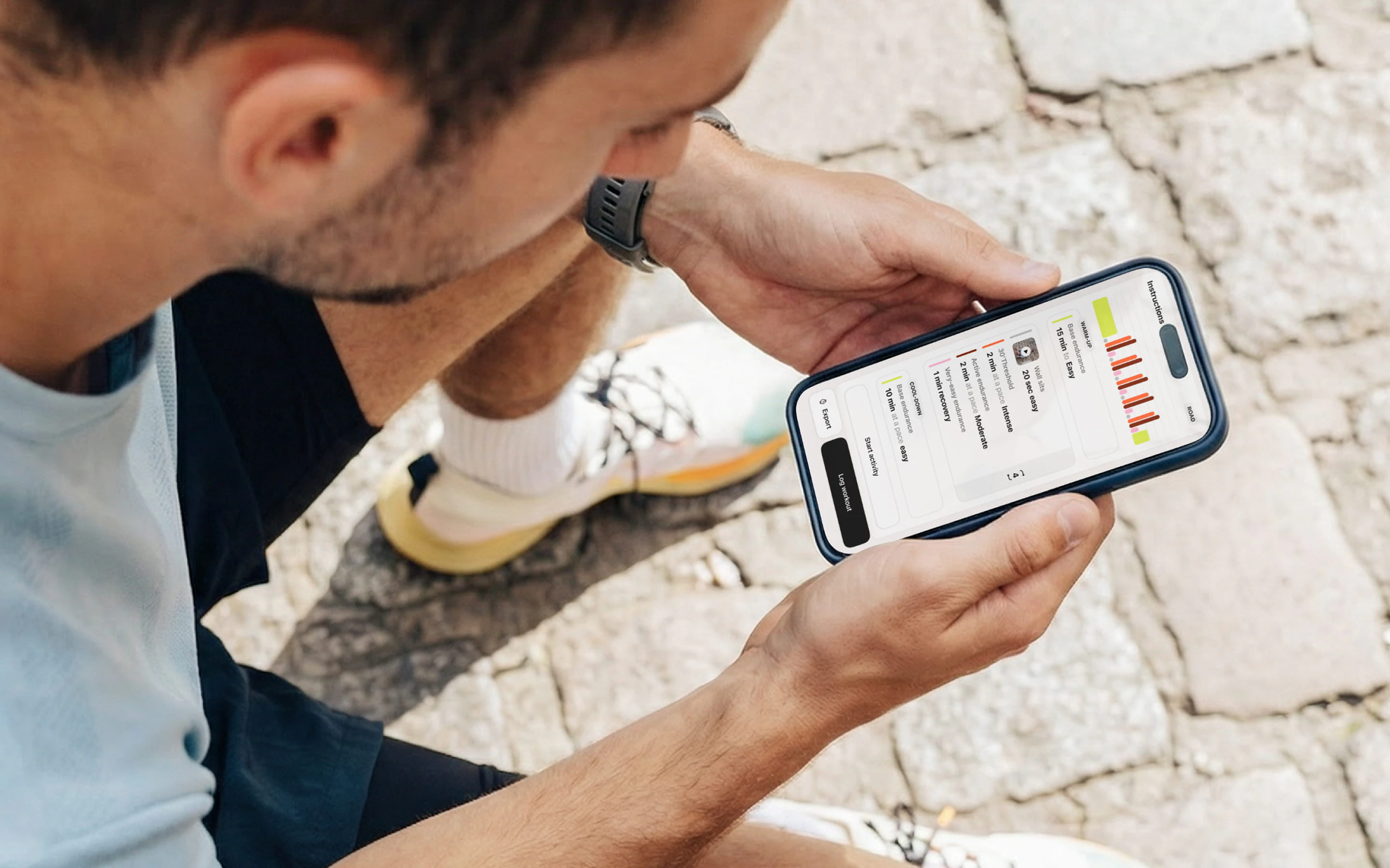 A runner sitting down, reading his daily workout on the Campus Coach app