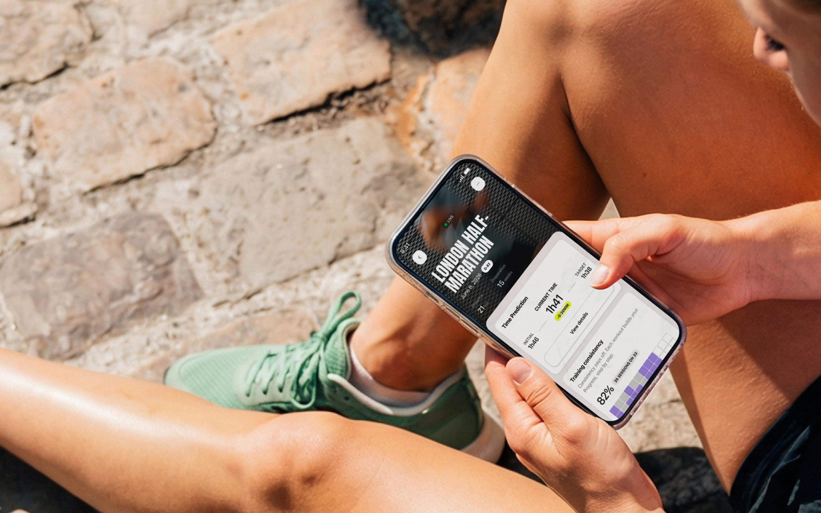 A runner sitting down, reading his goal prediction on the Campus Coach app