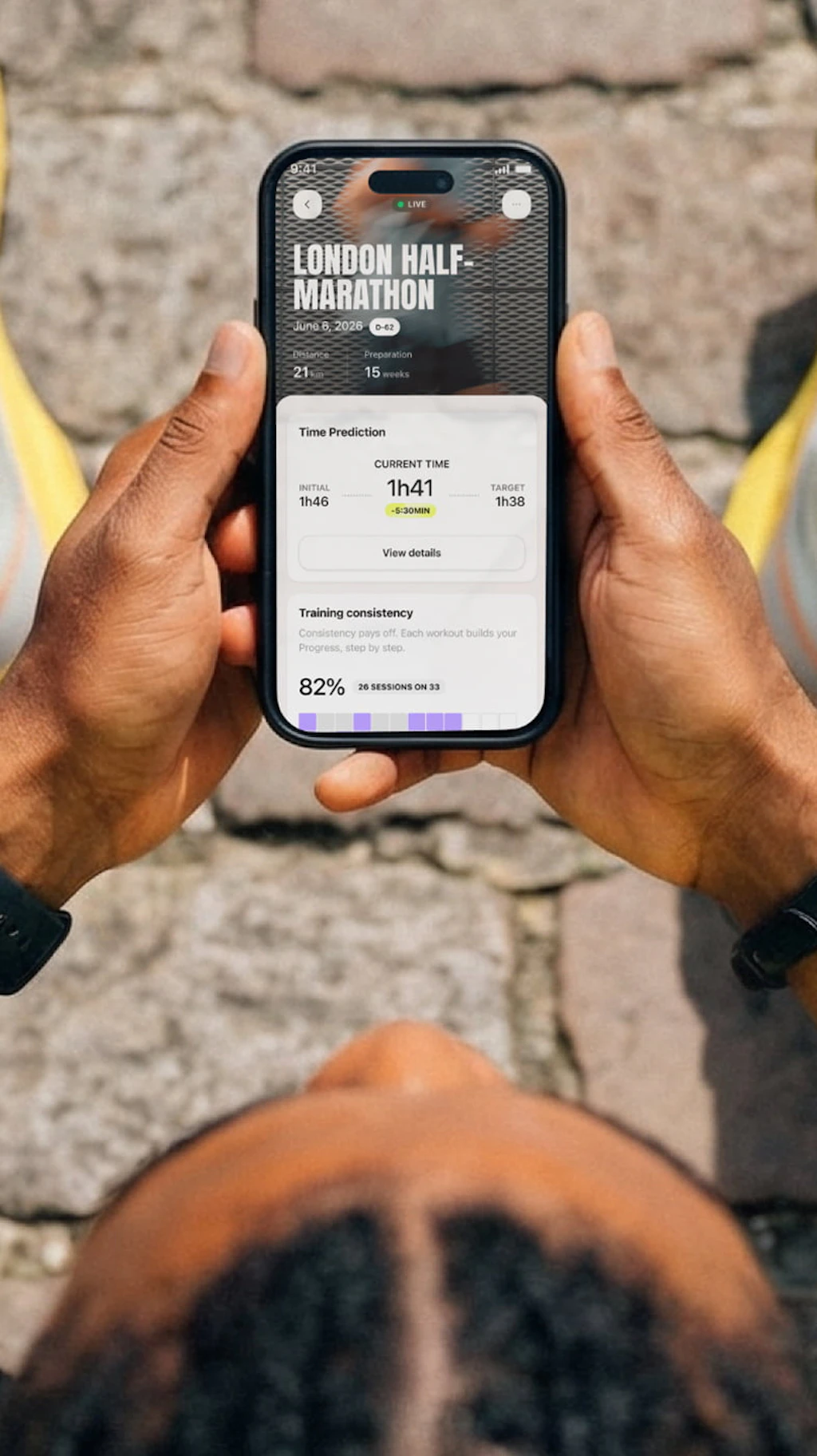A runner sitting down, reading his goal prediction on the Campus Coach app