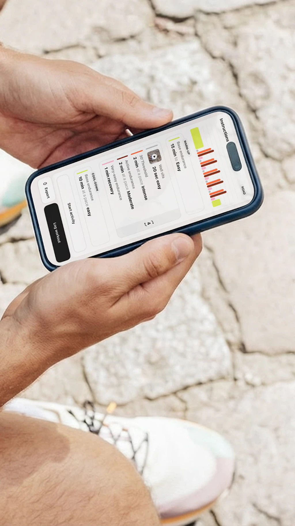 A runner sitting down, reading his daily workout on the Campus Coach app
