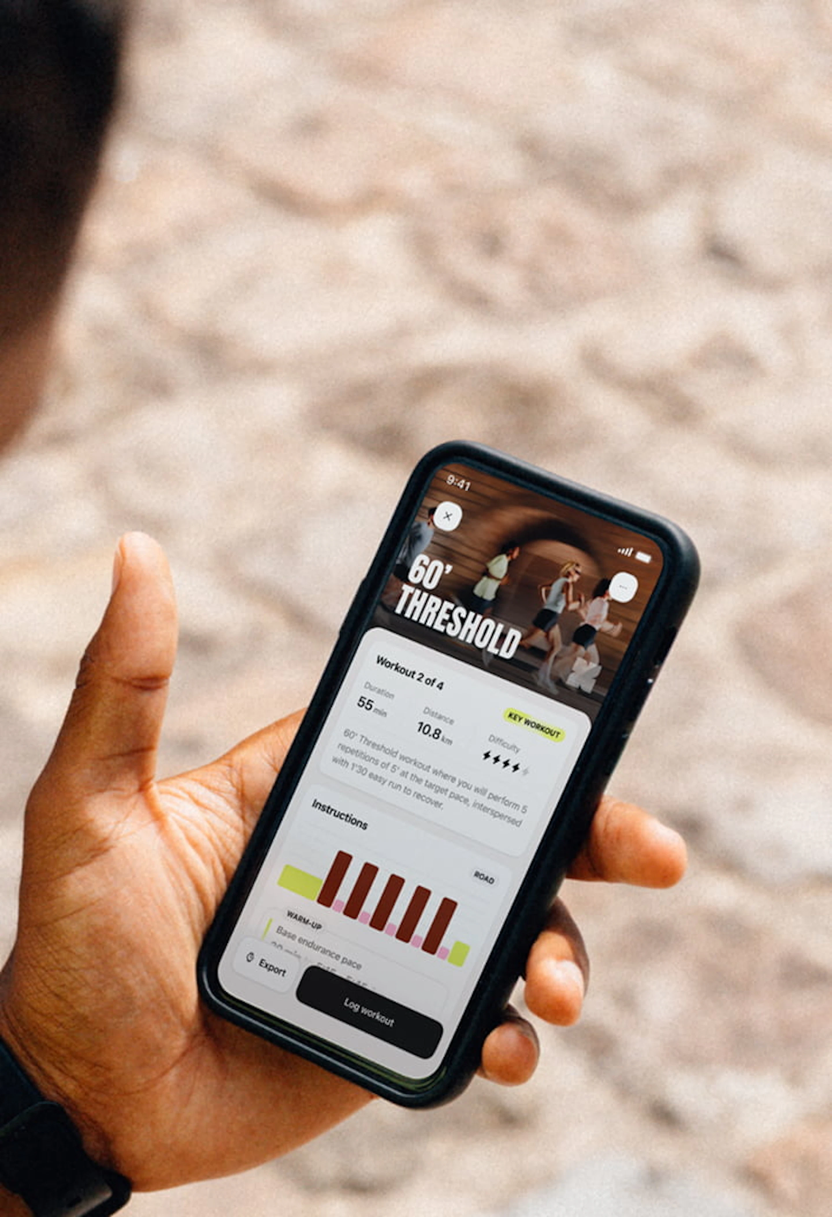 A runner sitting down, reading his daily workout on the Campus Coach app