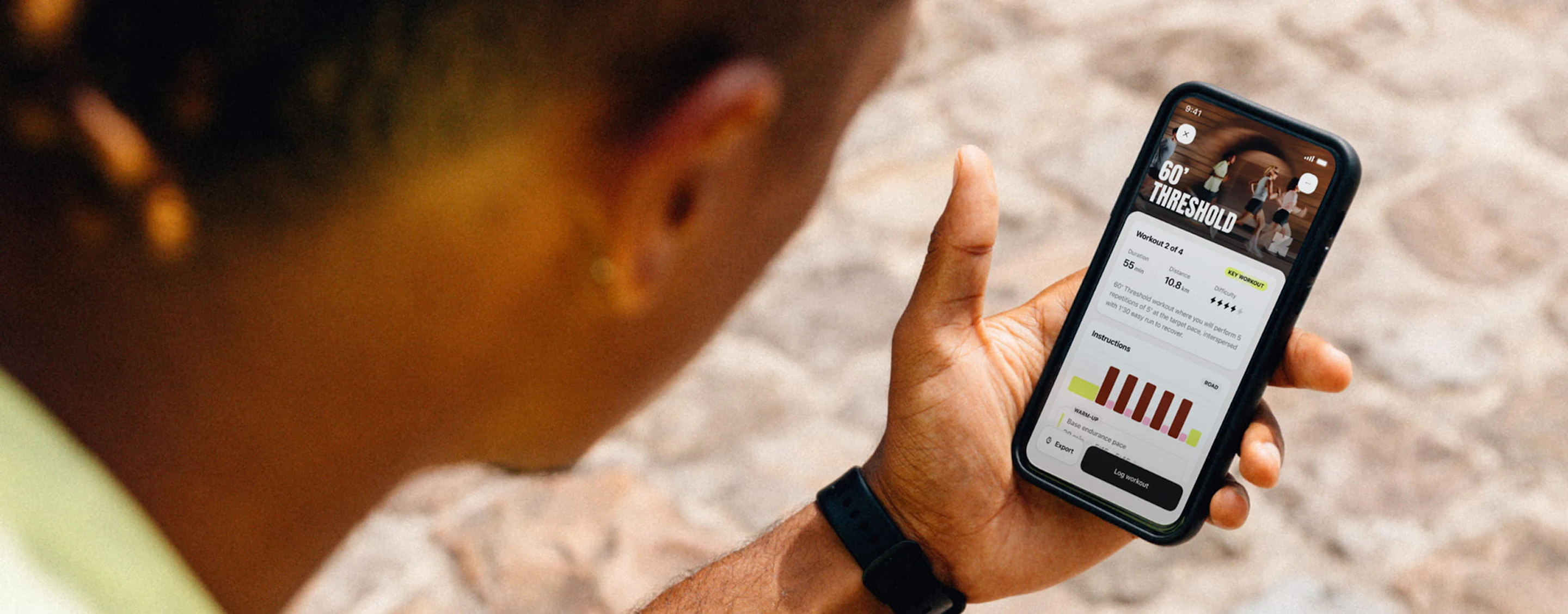 A runner sitting down, reading his daily workout on the Campus Coach app