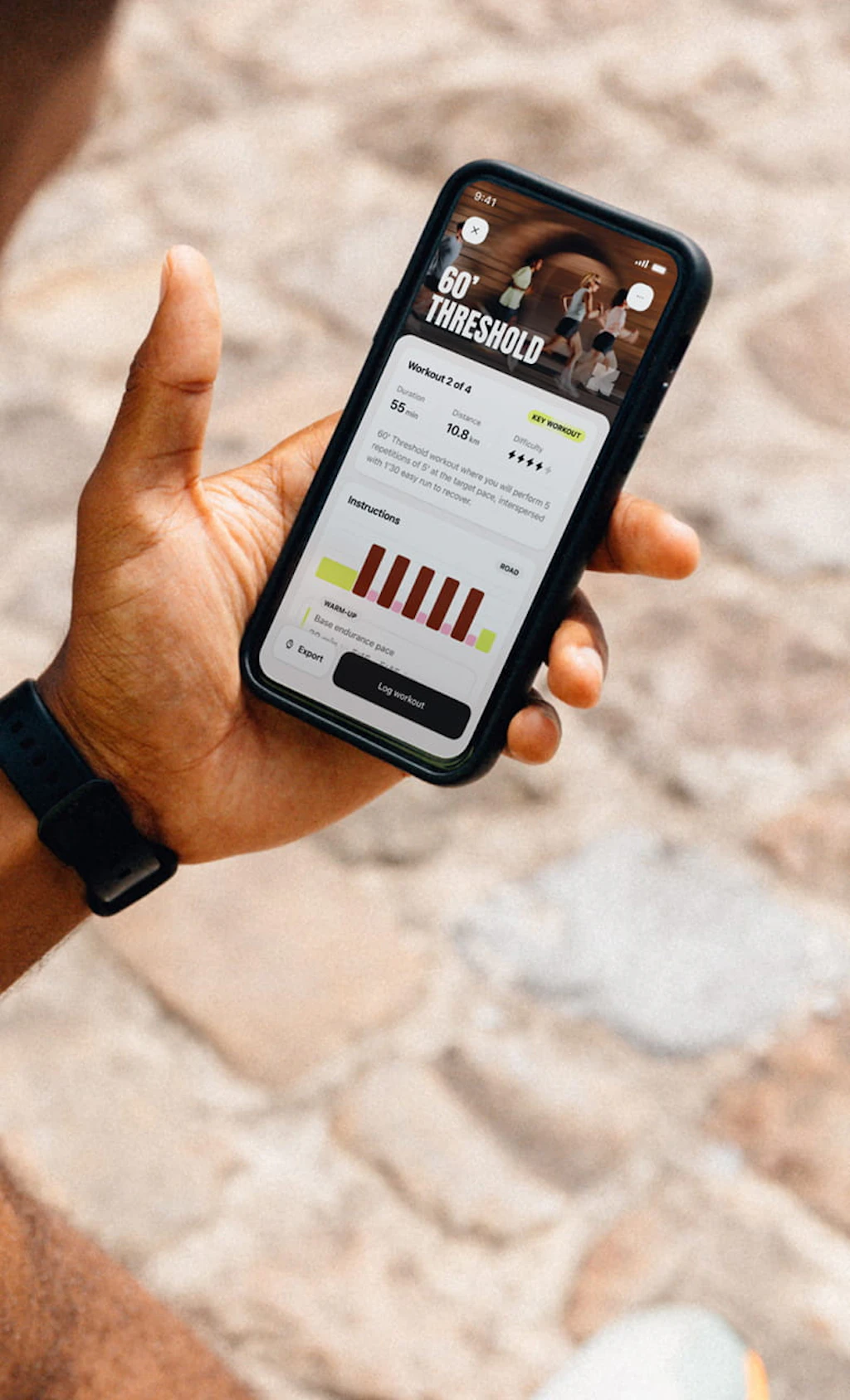 A runner sitting down, reading his daily workout on the Campus Coach app