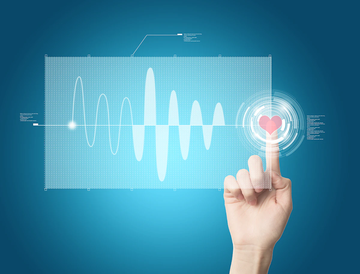 Un tracé électrocardiographique. Une main touche un cœur.
