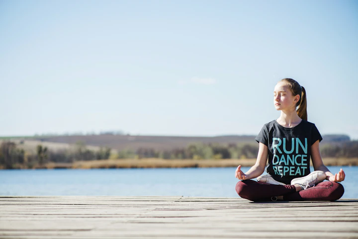 teenager sitting pier lotus position