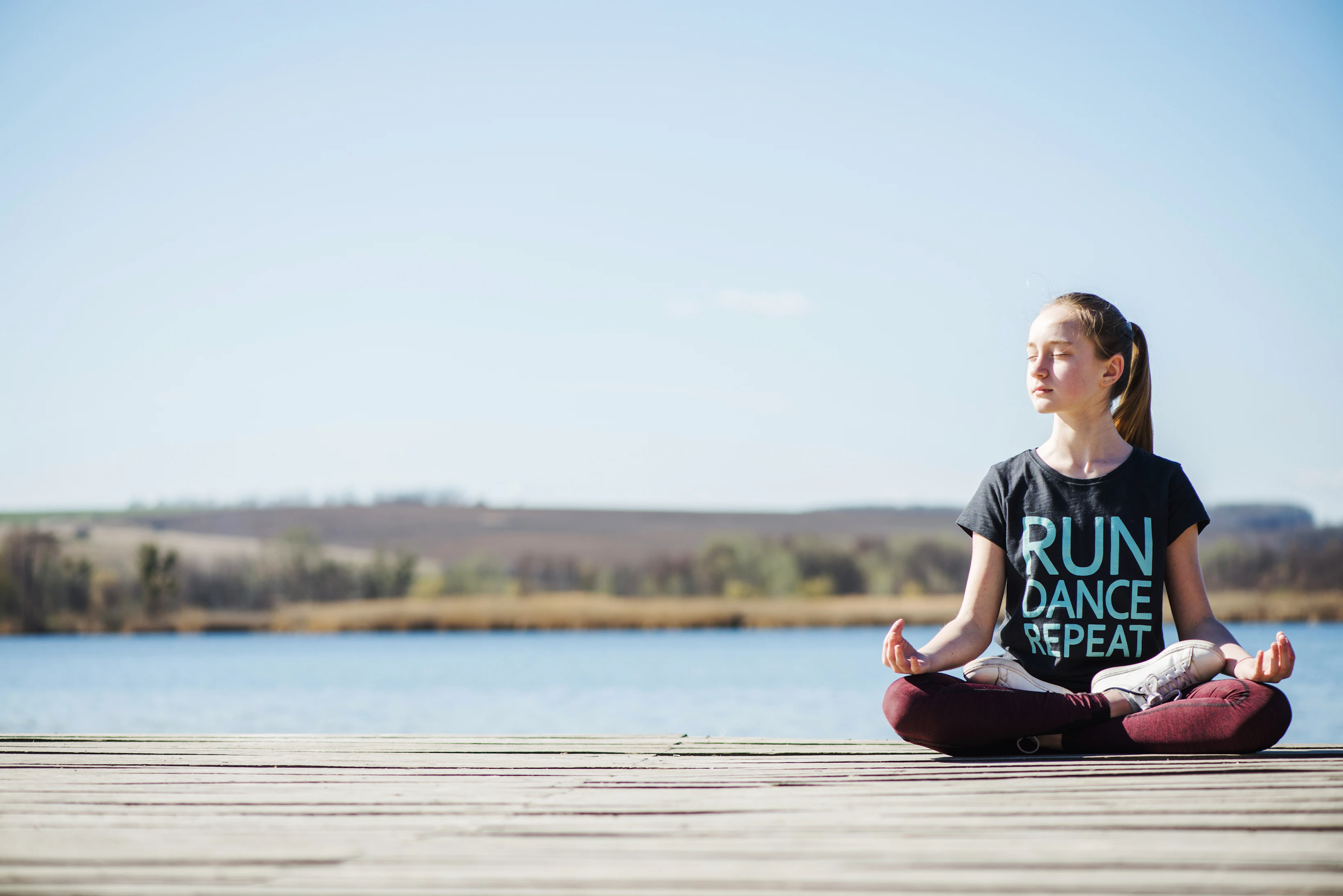 teenager sitting pier lotus position