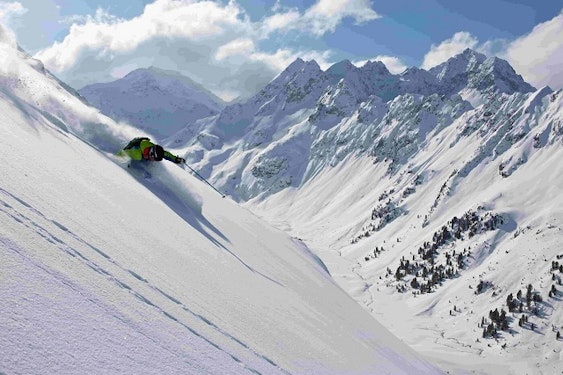 Off-piste powder skiing Skier in powder snow off-piste — freeride in the mountains