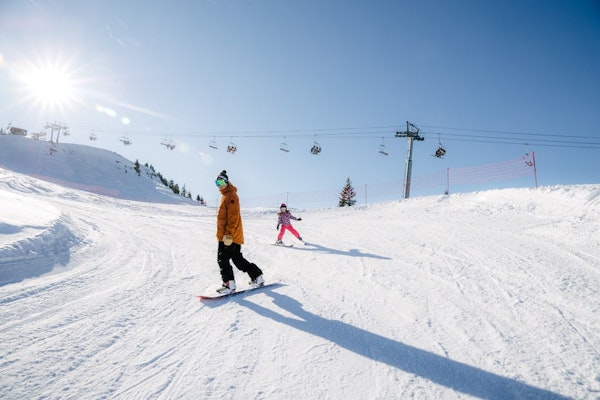 Snowboarder on the snowy slopes of Areches-Beaufort ski resort, Savoie