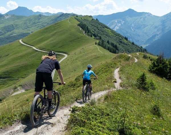 Mountain biking with views of Arêches-Beaufort mountains in summer, Savoie - Beaufortain