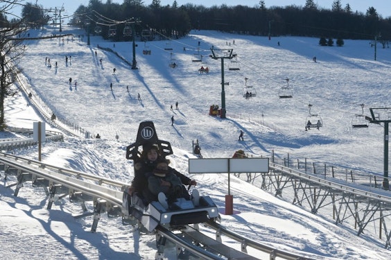 La Schlucht mountain coaster in winter Mountain coaster and snowy ski slopes at La Schlucht, Passe Montagne partner resort