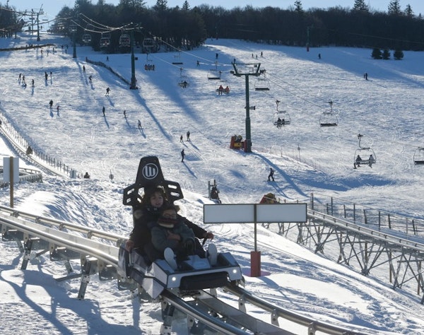 La Schlucht mountain coaster in winter Mountain coaster and snowy ski slopes at La Schlucht, Passe Montagne partner resort