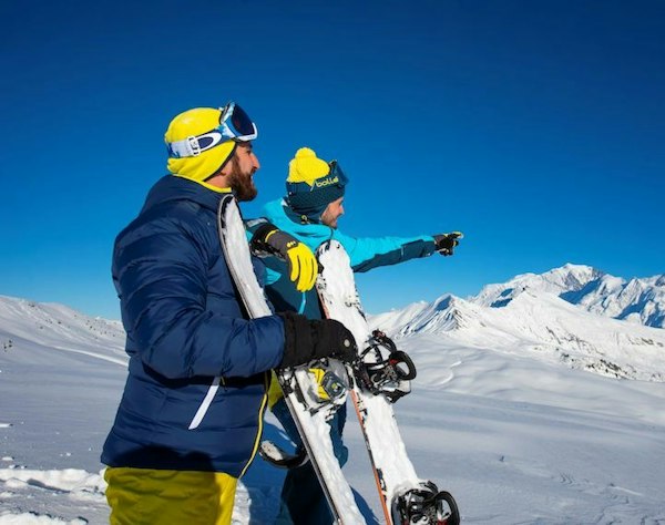 Forfait ski Crest-Voland Cohennoz pas cher | Passe Montagne Snowboardeurs observant les sommets enneigés depuis Crest-Voland Cohennoz en Savoie