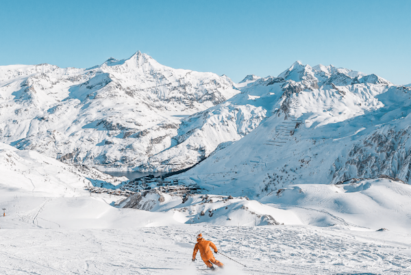 Skier facing the snowy Tignes peaks, Savoie