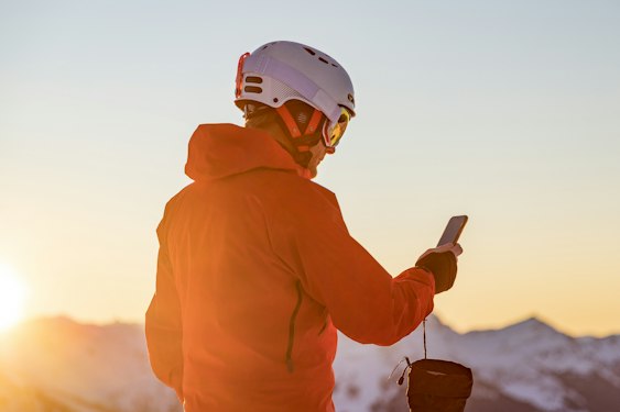 Skier checking her smartphone on the slopes