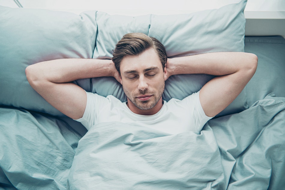 Mann entspannt im Bett