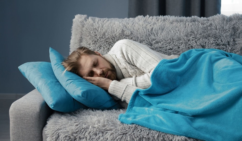 Mann schläft auf dem Sofa