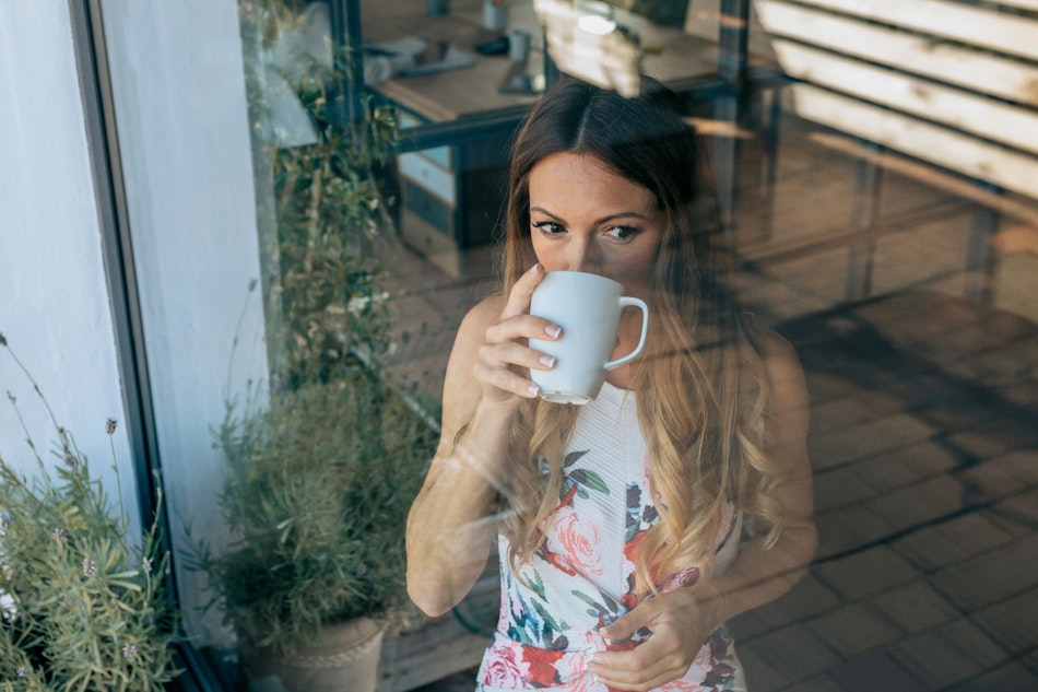 Frau entspannt mit einer Tasse während der Arbeitszeit