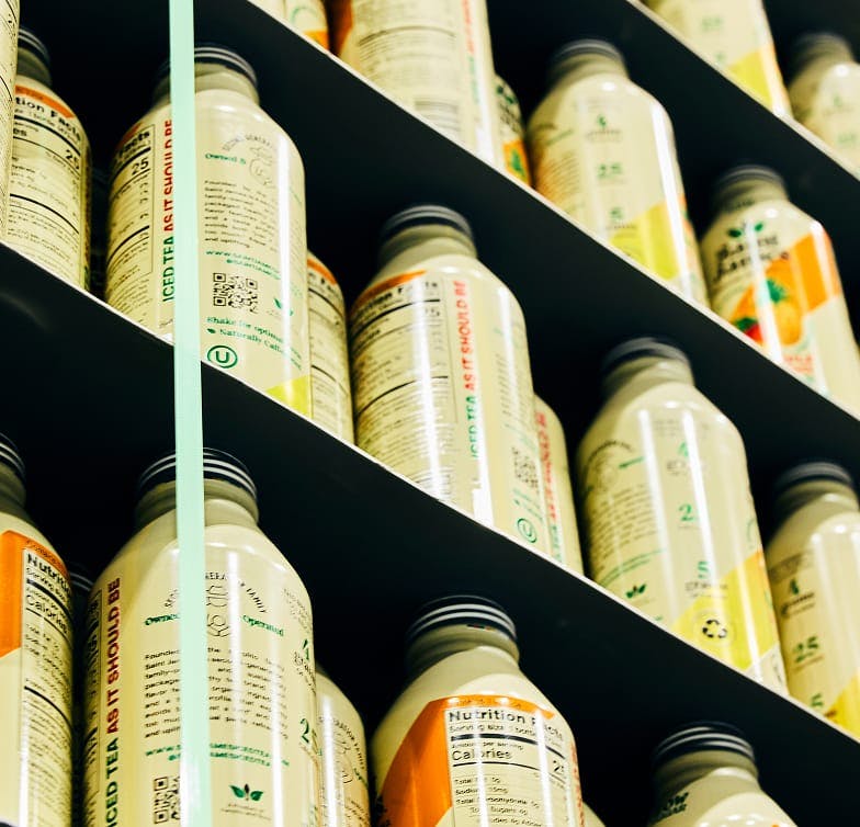 Close up of bottles with labels on multi tiered storage