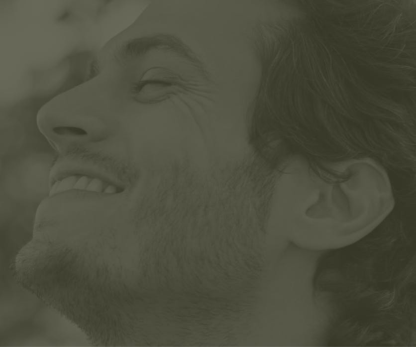 A faded image of a person smiling