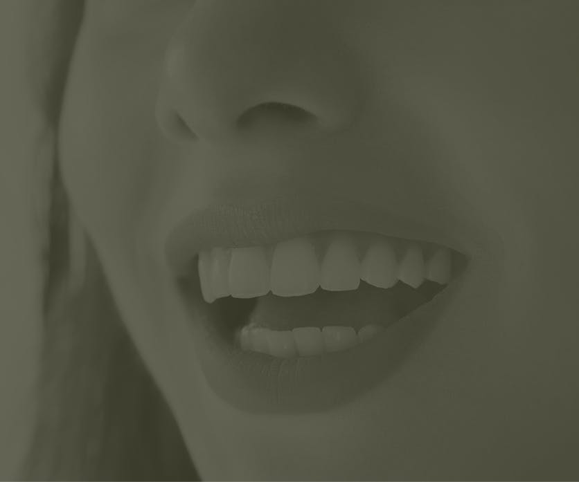 Faded image of a woman smiling