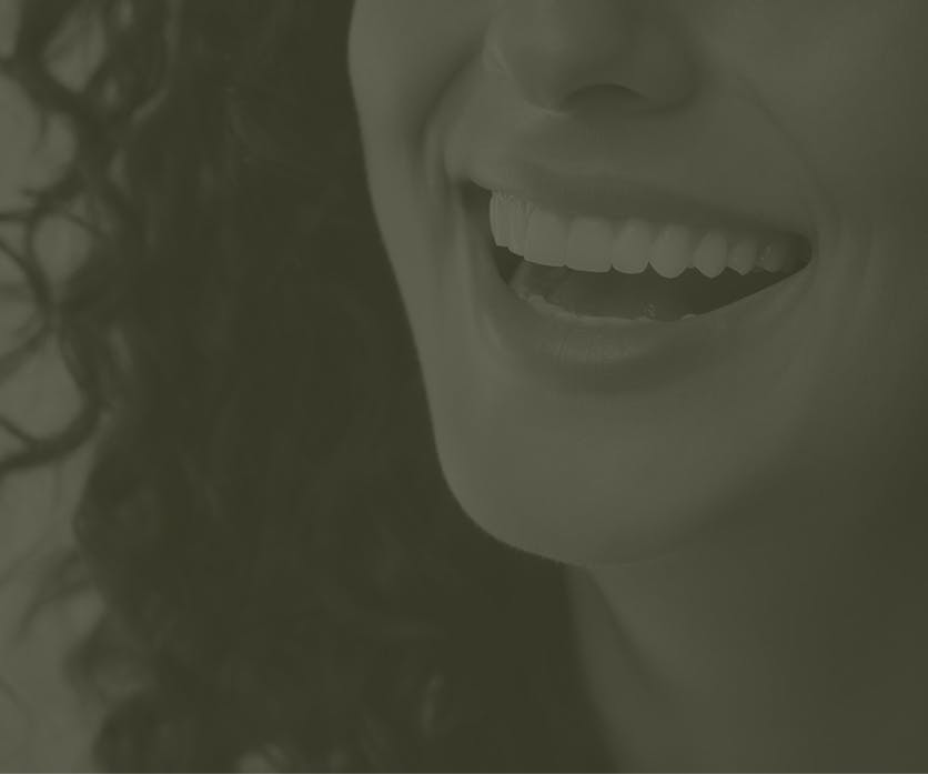 Faded image of a person smiling