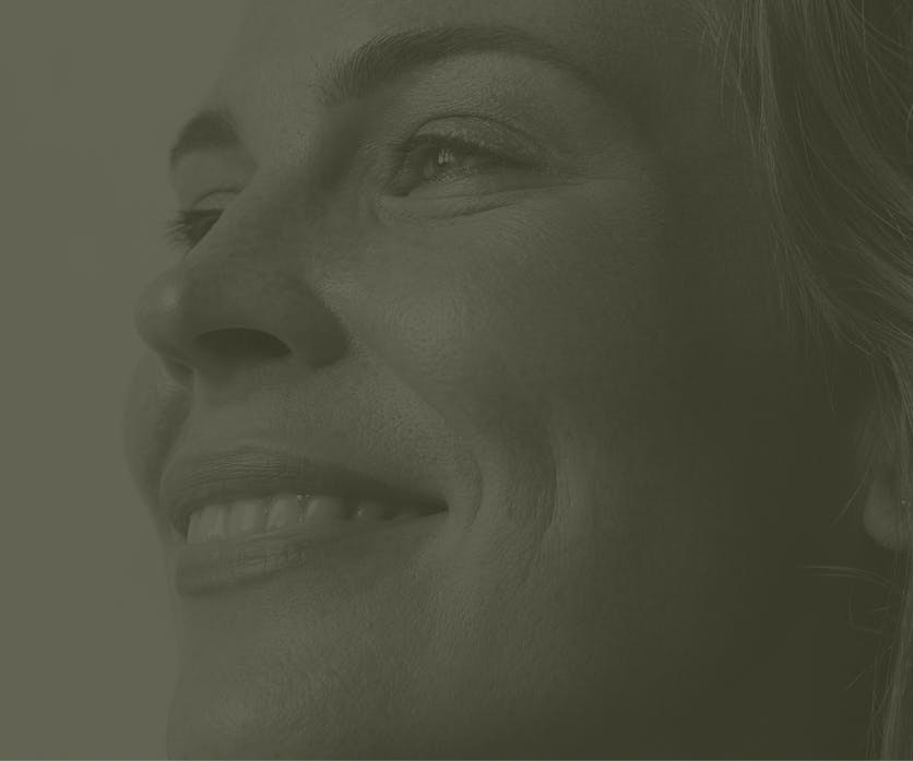 Faded image of a woman smiling