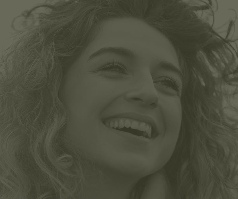 Faded image of a woman smiling