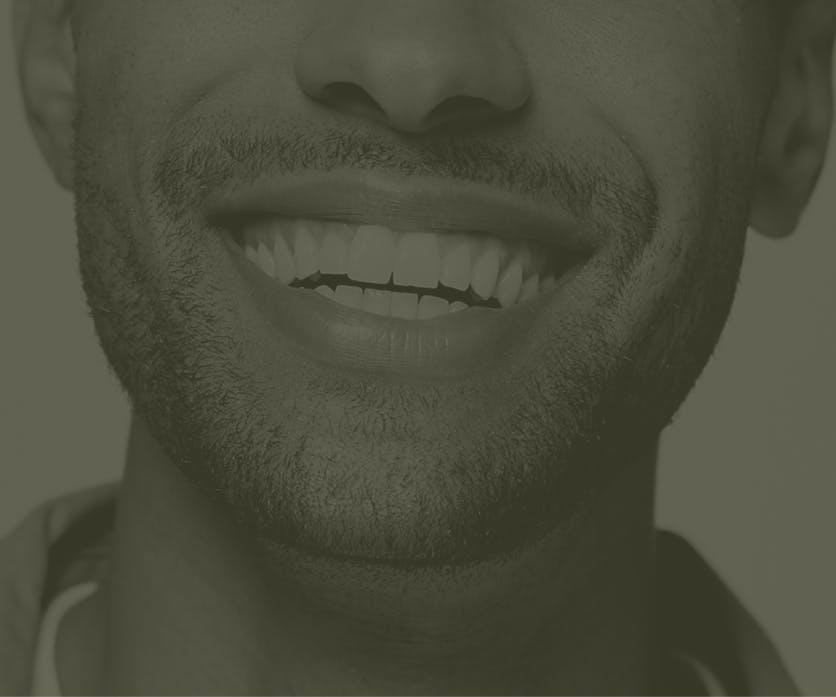 A faded image of a person smiling